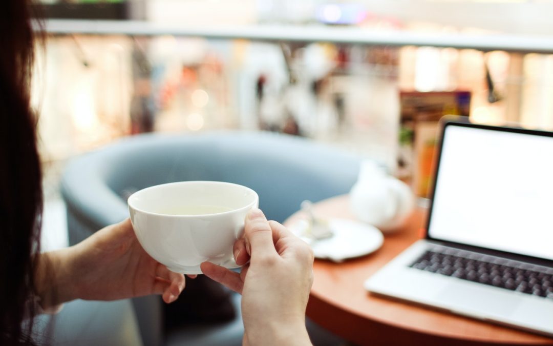 person-holding-white-ceramic-teacup-in-front-of-a-macbook-210658-1080x675